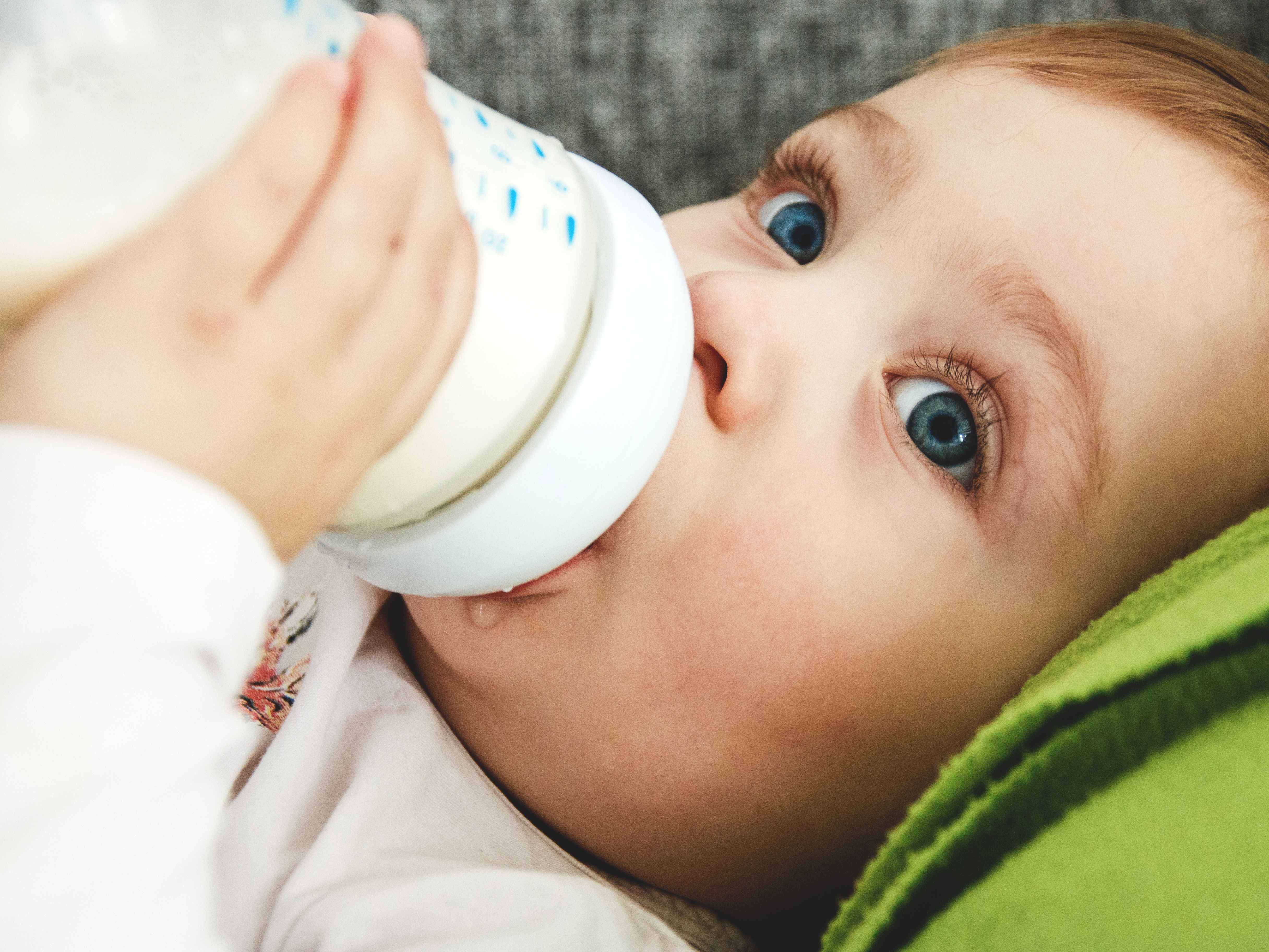 close-up-child-drinking-milk-from-bottle